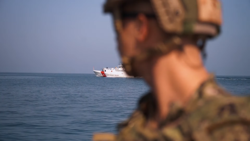 A U.S. Coast Guard Member Looking at A Boat