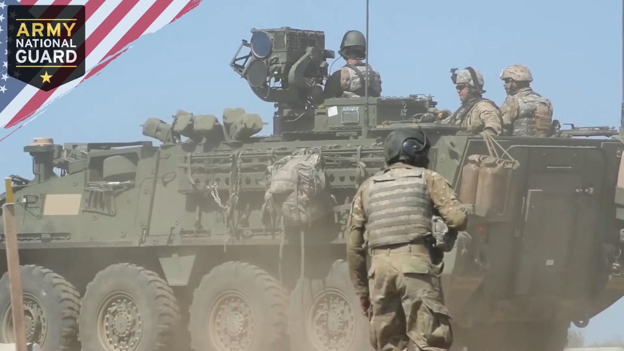 Military vehicle is shown in action with soldiers on board, emphasizing the operational readiness of the U.S. Army National Guard