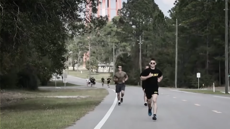 A Group of Soldiers Runs Along a Paved Road, Following the Structured Weekly Training Layout of The 12-Week Military Running Program