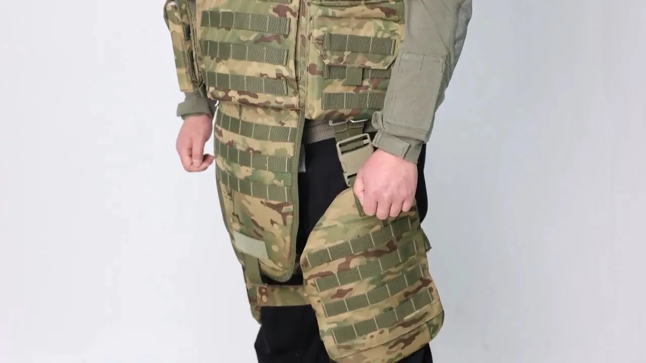 Person wearing a camouflaged bulletproof vest, showing the vest's details and design, set against a plain background to highlight the body armor