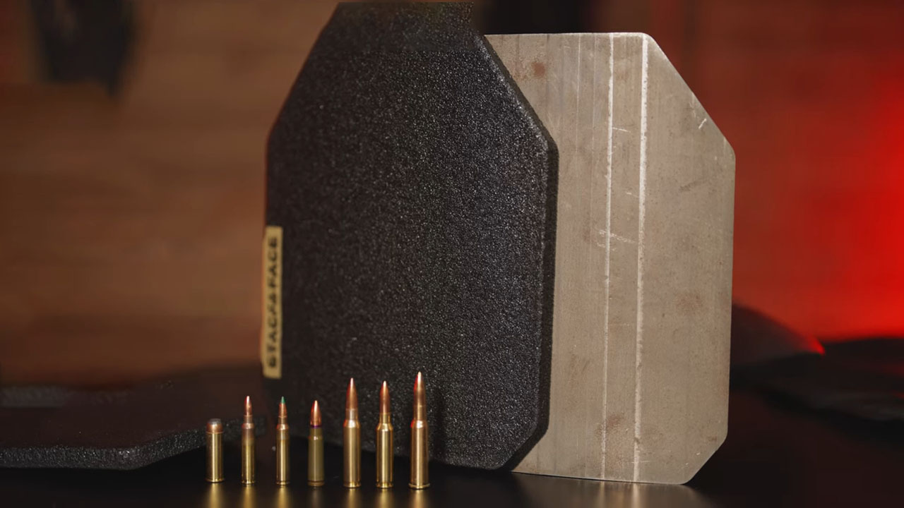 Two body armor plates next to several bullet calibers, showing size and protection comparison