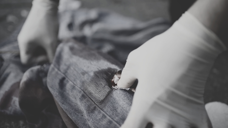 A Person Administering First Aid to A Gunshot Wound