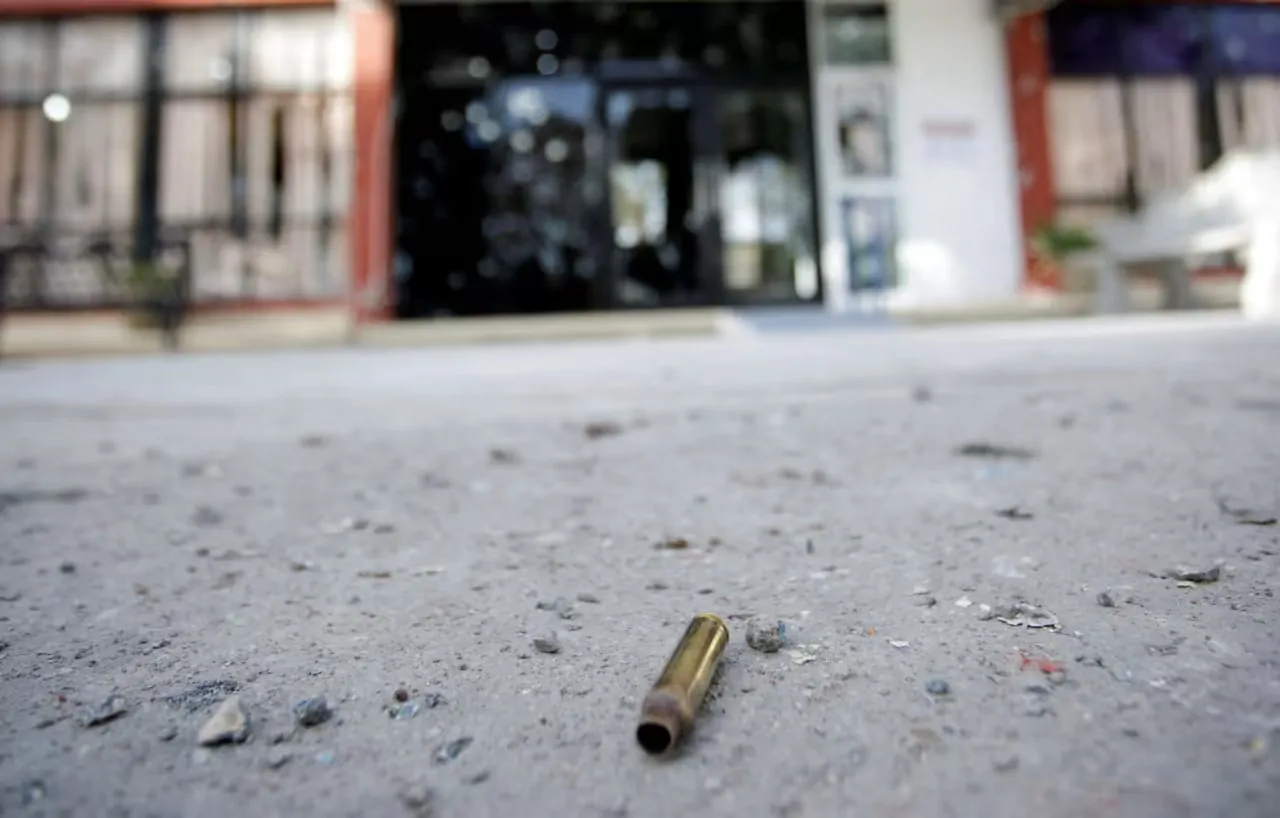 A single bullet on the concrete floor.