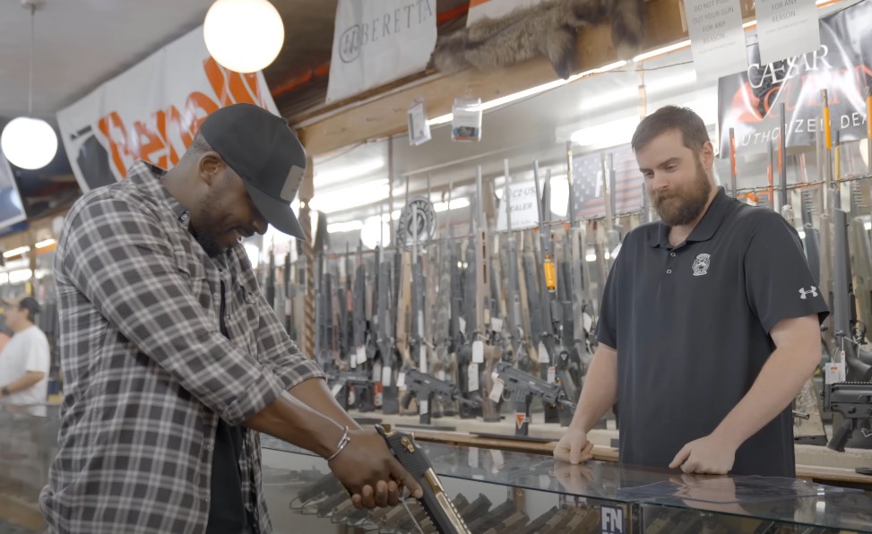 Man buys a handgun for self defense in a gun store