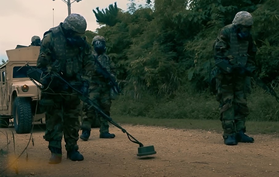 Ordnance Corps detecting exploding mines in the ground