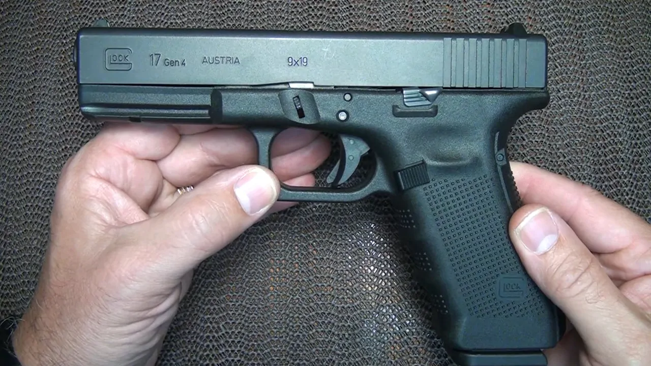 Close-up of a Glock 17 Gen 4 pistol being held in both hands, showcasing its design