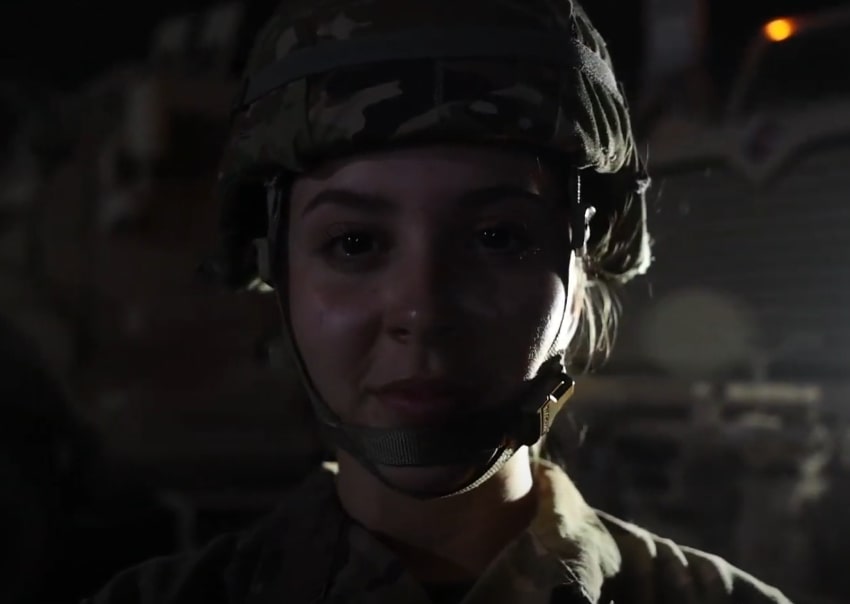 Close-up of a young military personnel wearing a helmet and uniform