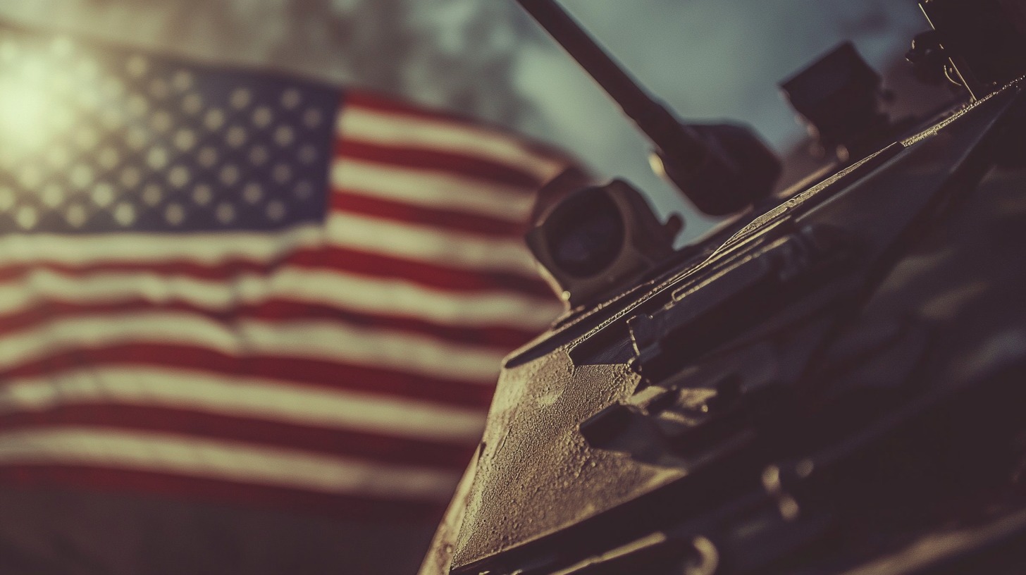 Close-up of a military vehicle with the American flag in the background, illuminated by warm sunlight