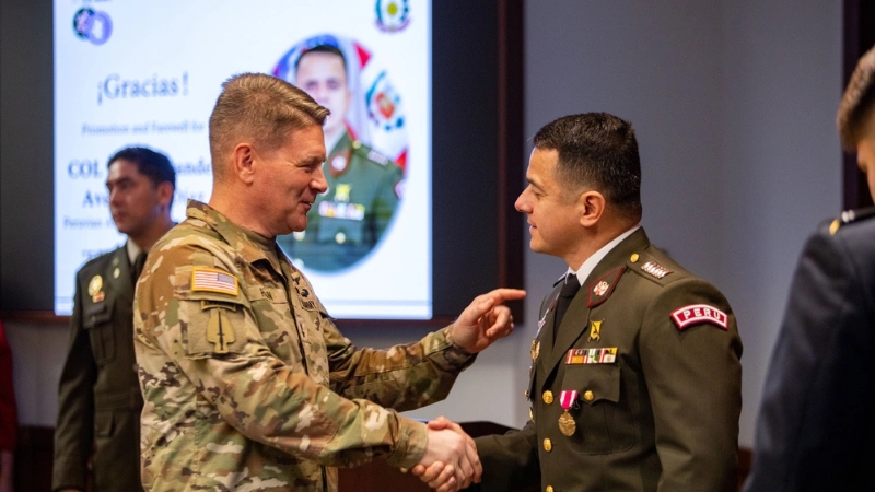 Peruvian Liaison Officer Shakes Hands with A U.S. Army Official After Being Promoted to Colonel