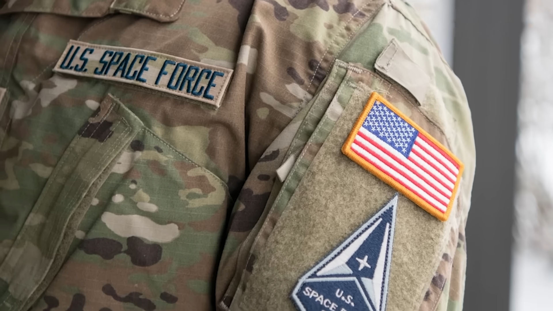 Close-up of a U.S. Space Force uniform with an American flag patch and Space Force insignia