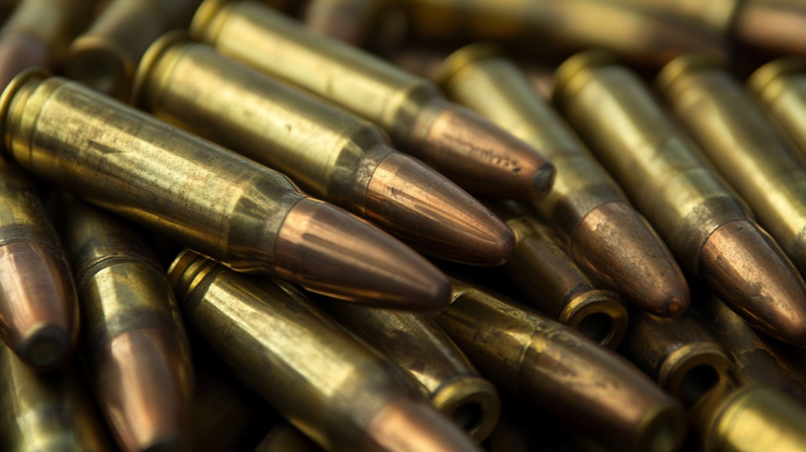 Close-up of brass rifle bullets stacked together, showing detailed tips and casings