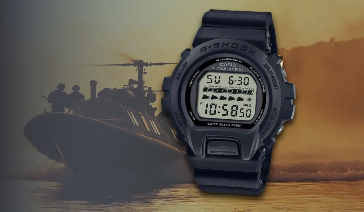 A rugged Casio G-Shock DW-6600 digital watch with a military boat and helicopter in the background