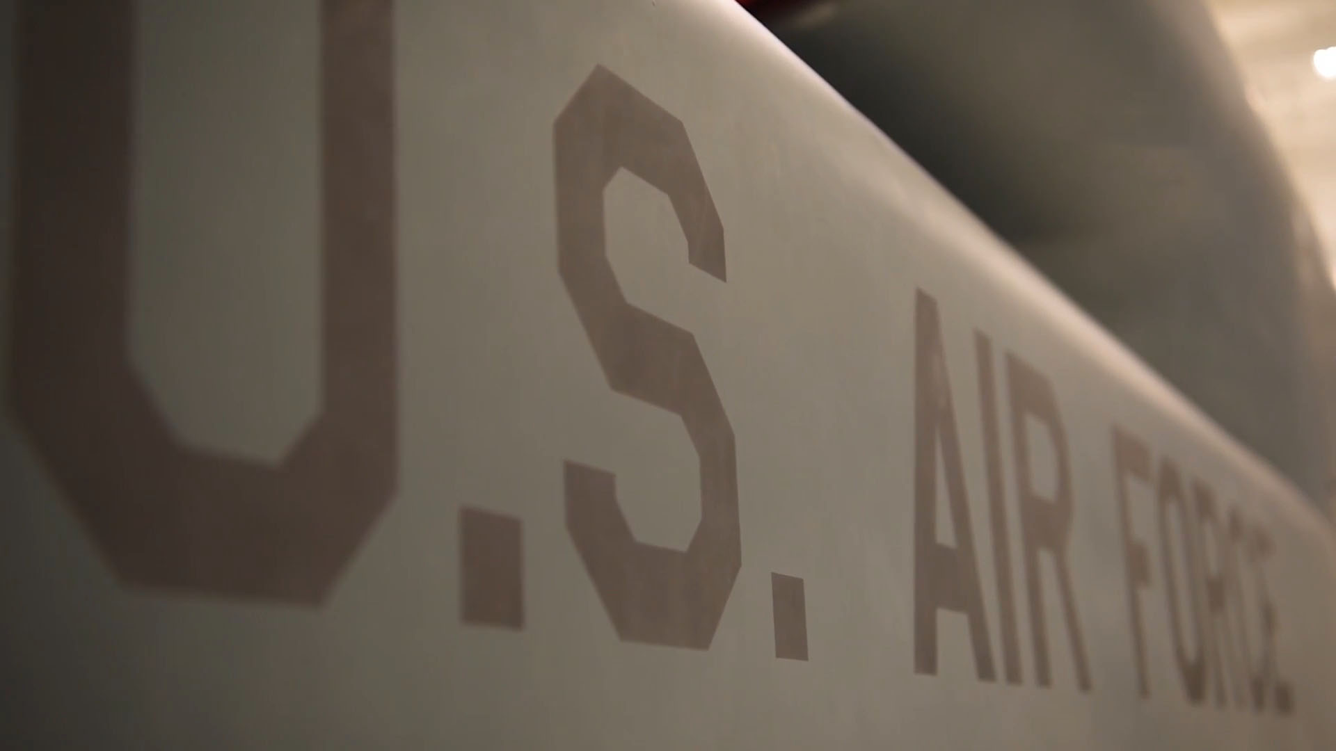 Close-up view of "U.S. Air Force" text on the side of an aircraft, with a Military TV logo in the corner