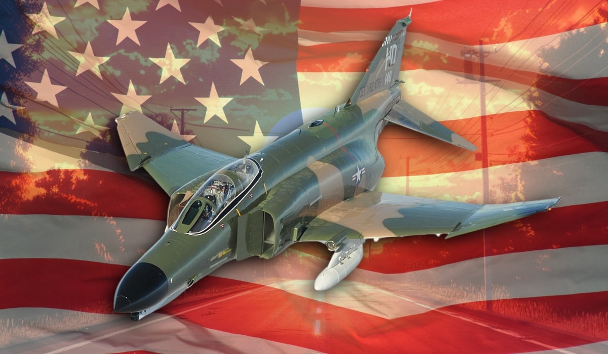 An F-4 Phantom II military jet with a camouflage pattern, overlaid on an American flag background