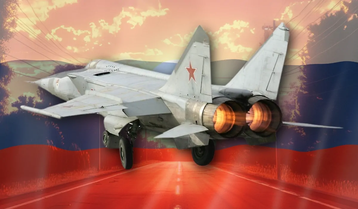 A Russian MiG-25 Foxbat fighter jet with afterburners engaged, taking off against the backdrop of the Russian flag and a sunset road