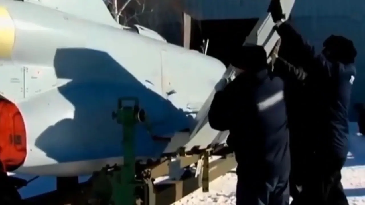 Military personnel working on a Tupolev Tu-300 drone, adjusting its components in a snowy environment