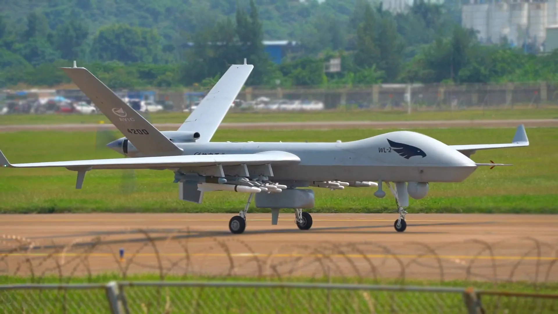 A Wing Loong II unmanned aerial vehicle (UAV) on the runway, equipped with multiple missiles under its wings